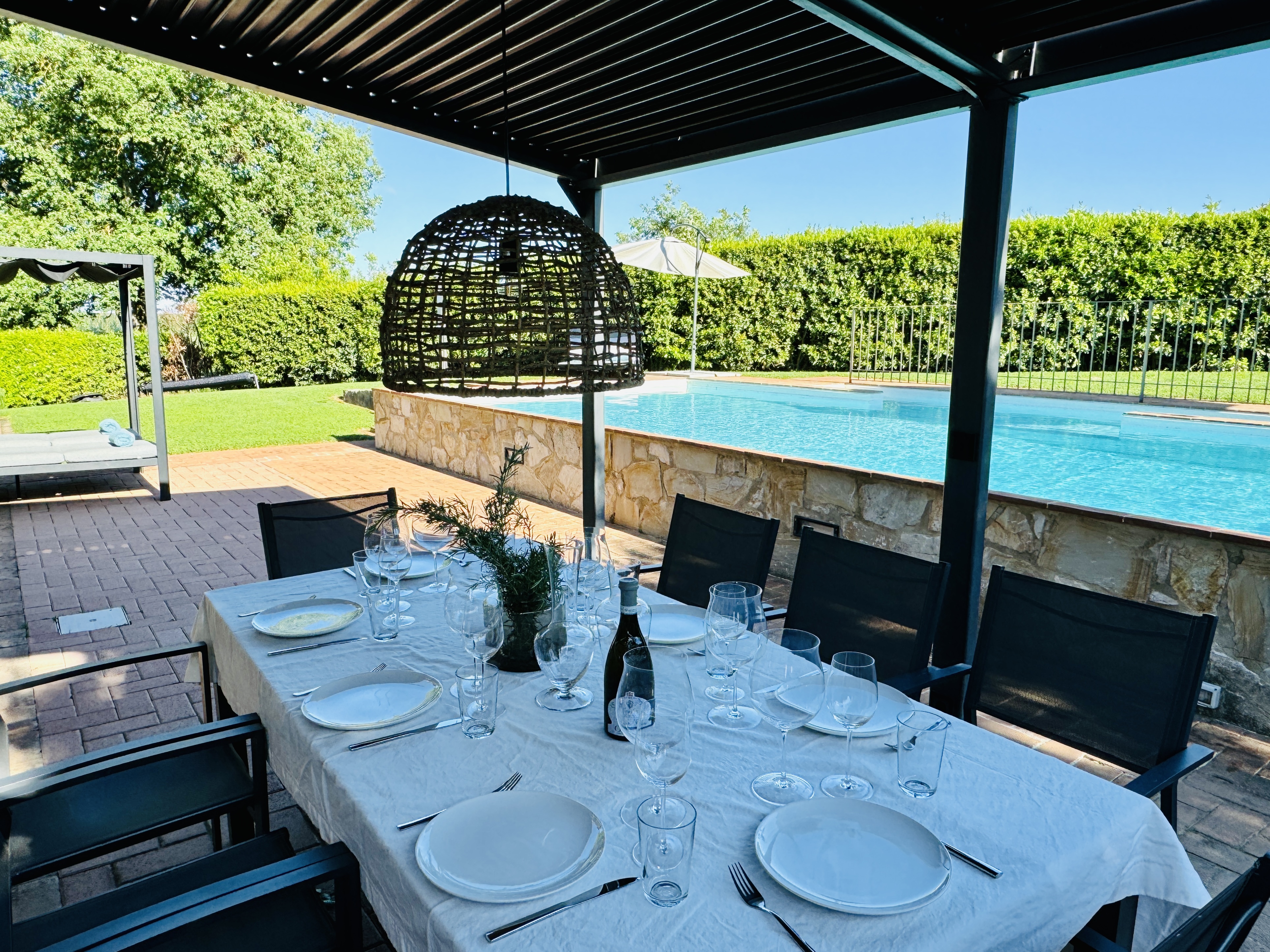 Outdoor dining patio with pool and Chianti view
