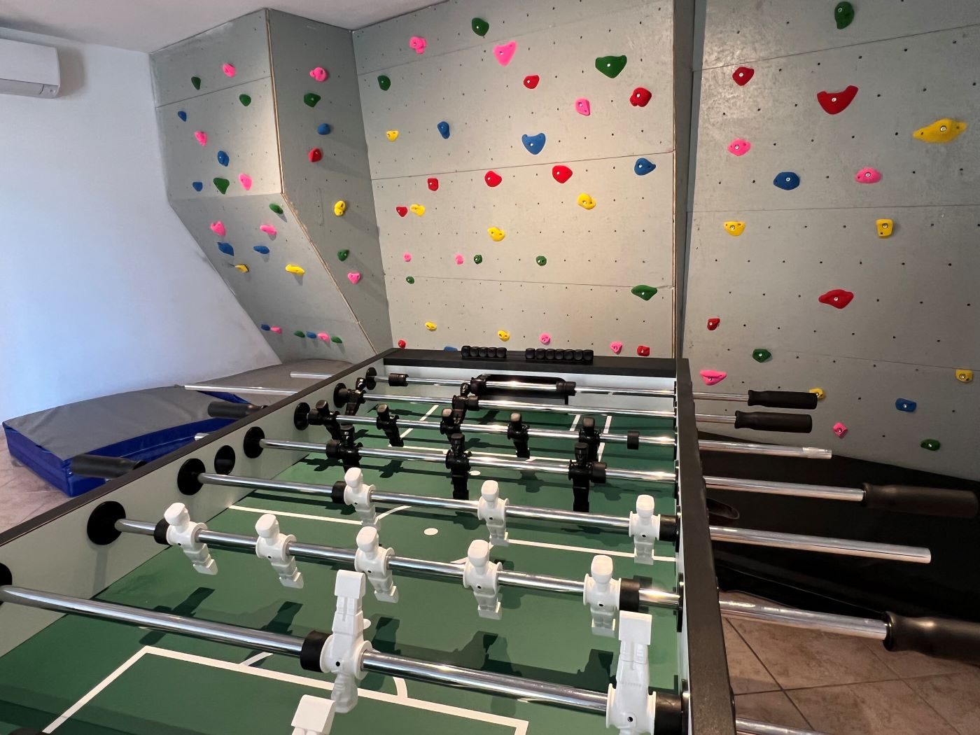 Climbing wall and games room with table football