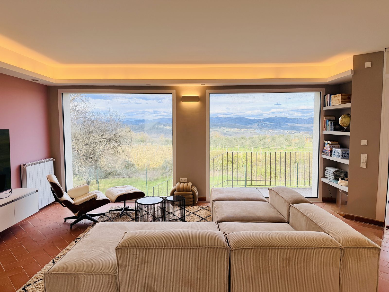 Floor-to-ceiling panoramic windows overlooking Chianti Classico vineyards