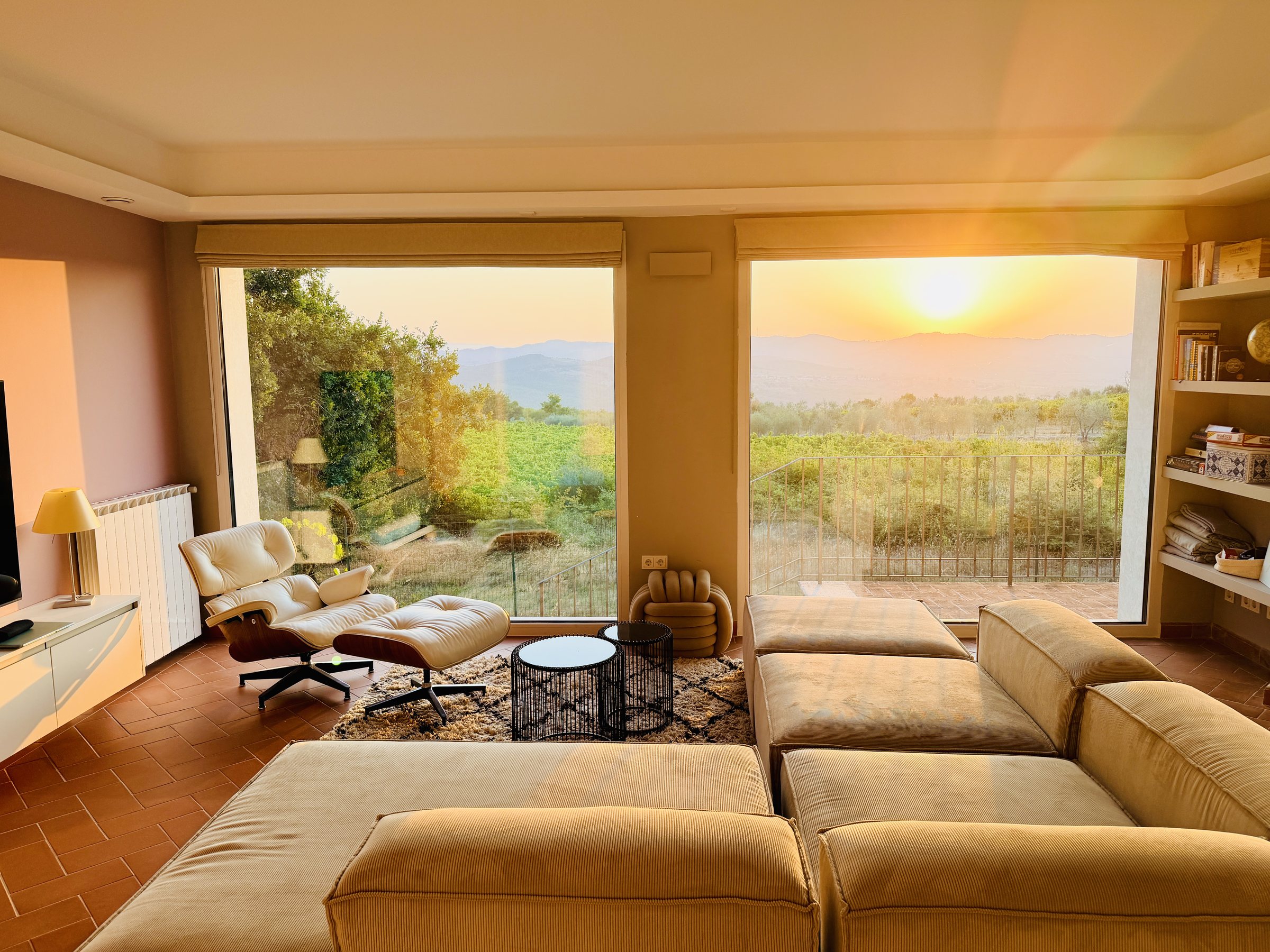 Living room at sunset with the evening sun over the Chianti hills