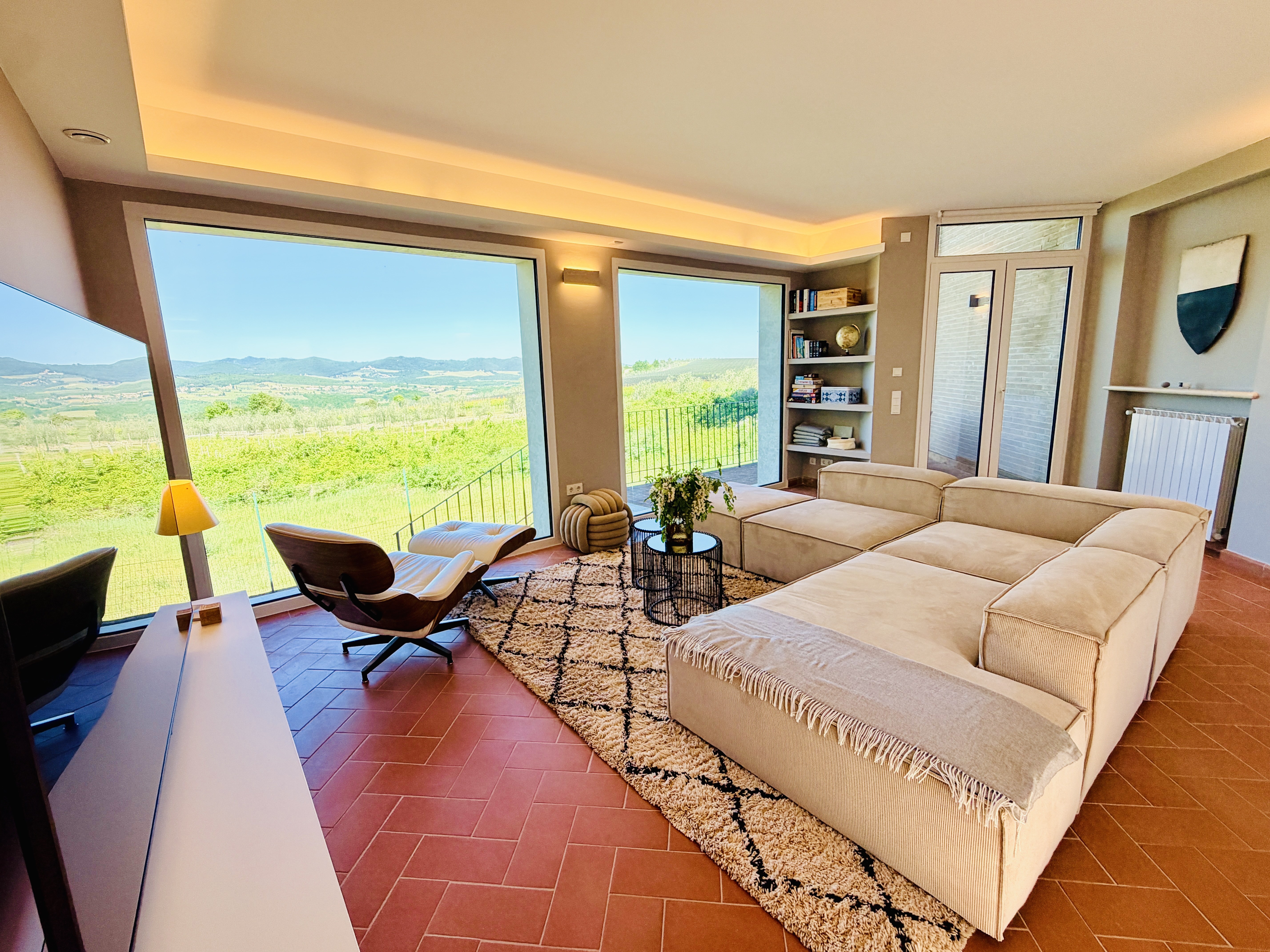 Living room wide angle with terracotta floor and Chianti view