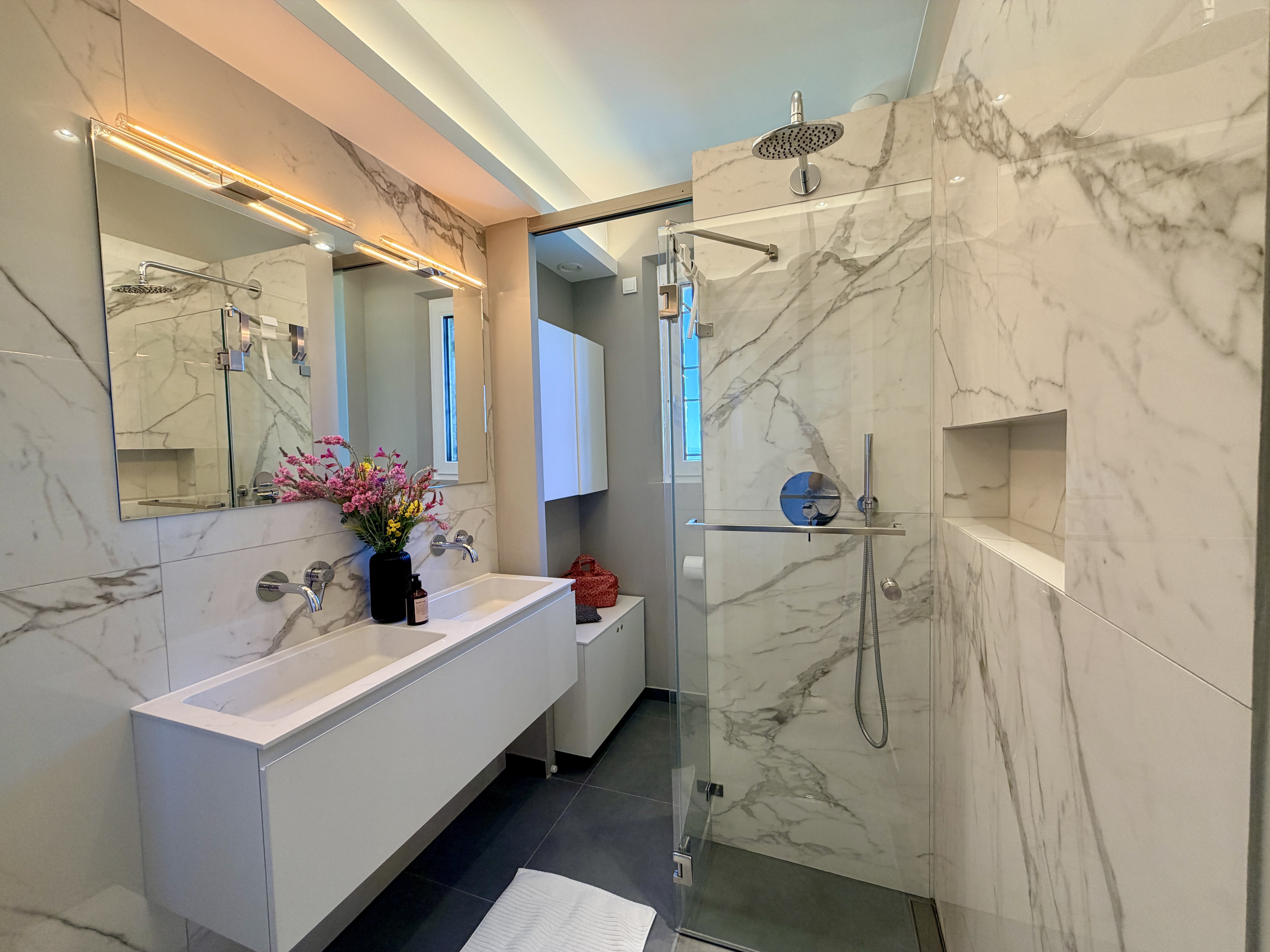 Master Bathroom 1 with marble walls, double basin and rain shower
