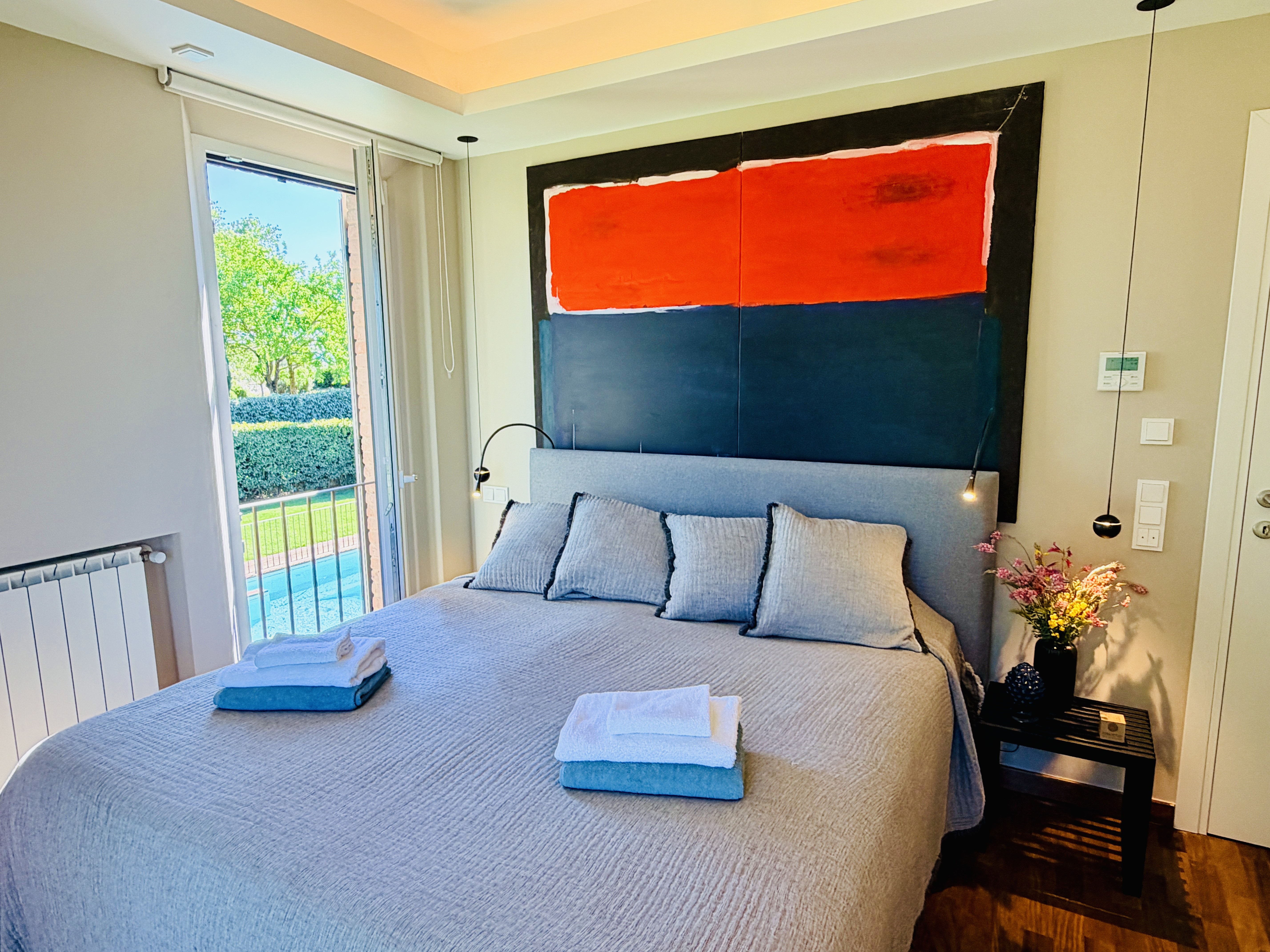 Master Bedroom 1 with pool access and garden view